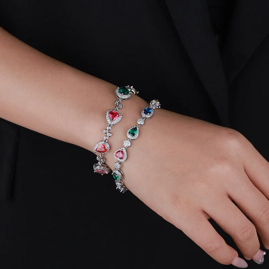 Bracelet with colorful gemstones on a wrist against a black background